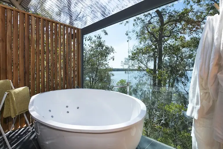 Jetted tub with forest and lake views at Eumarella Shores Noosa Lake Retreat